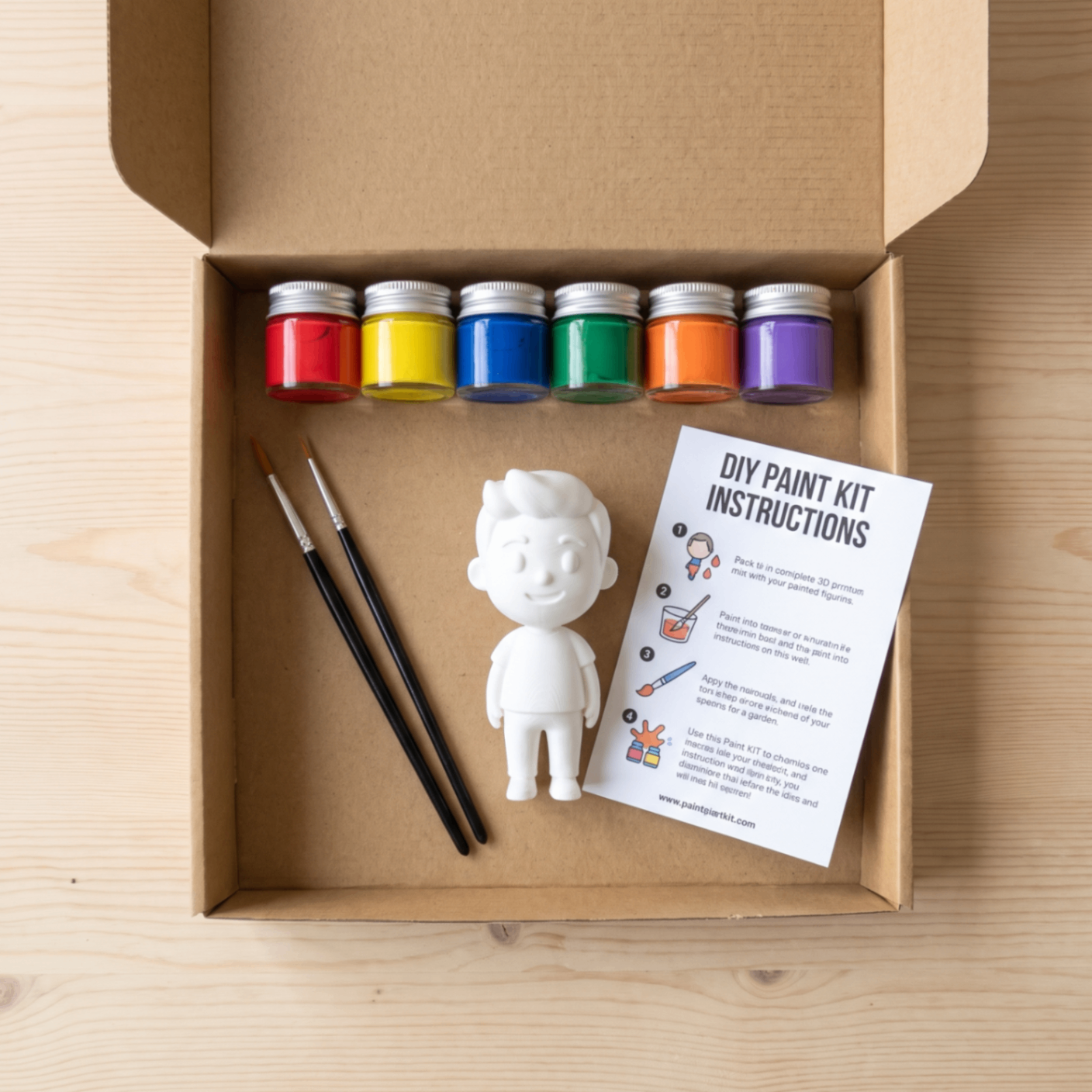 DIY paint kit with paints, brushes and a blank figurine